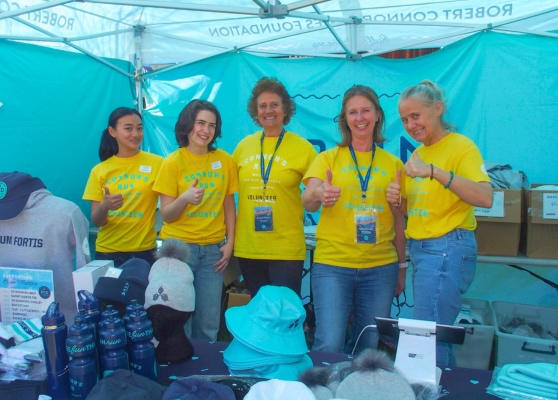 volunteers at merch tent